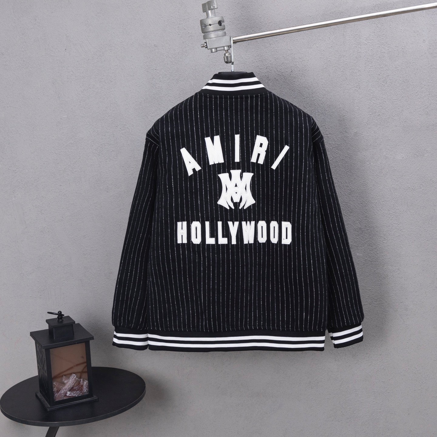 Pinstripe varsity jacket with AMIRI back graphic and striped cuffs