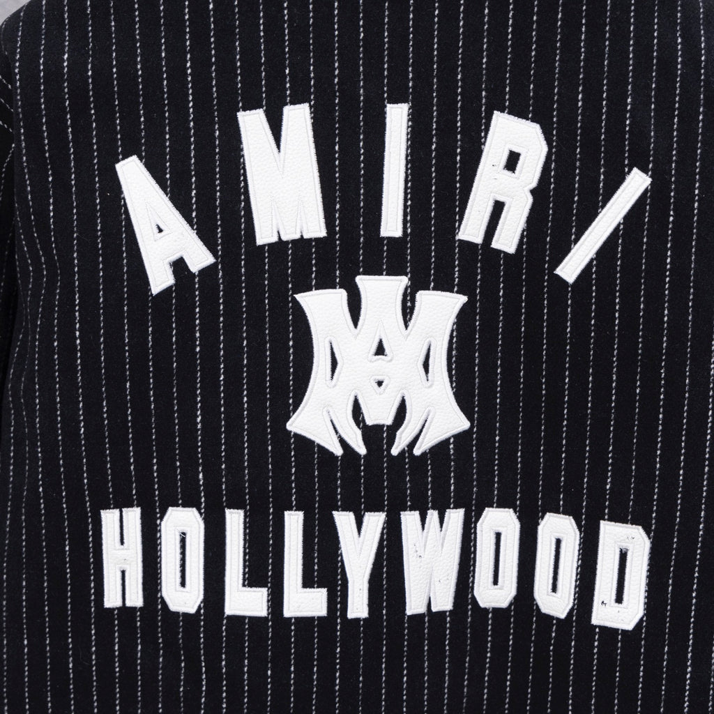 Pinstripe varsity jacket back graphic with 'AMIRI' and 'HOLLYWOOD' text