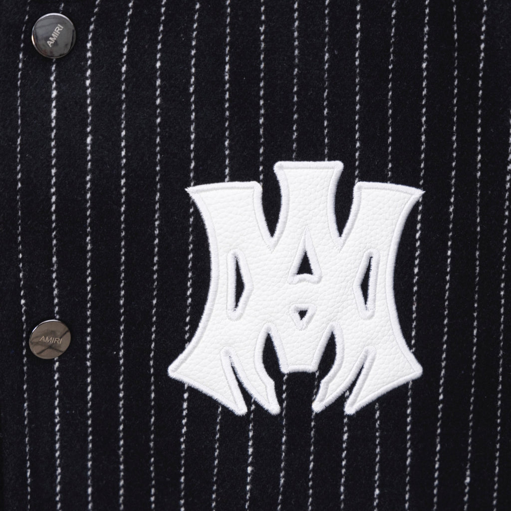 White AMIRI logo patch on dark pinstripe varsity jacket