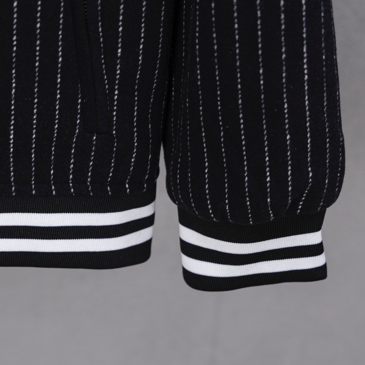 Pinstripe varsity jacket hem with wide striped cuffs in white and dark