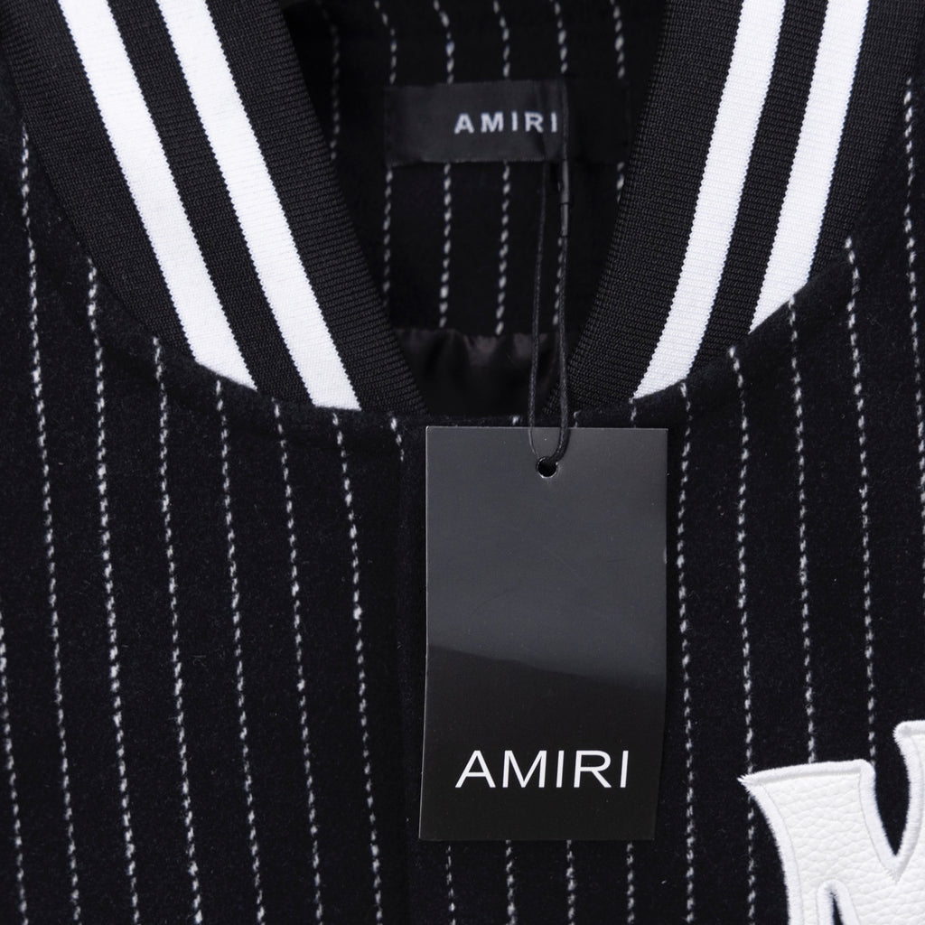 AMIRI logo patch detail on pinstripe varsity jacket, with hanging tag