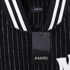 AMIRI logo patch detail on pinstripe varsity jacket, with hanging tag
