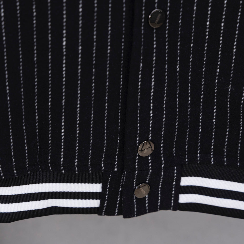 Pinstripe varsity jacket front with button placket and striped hem band