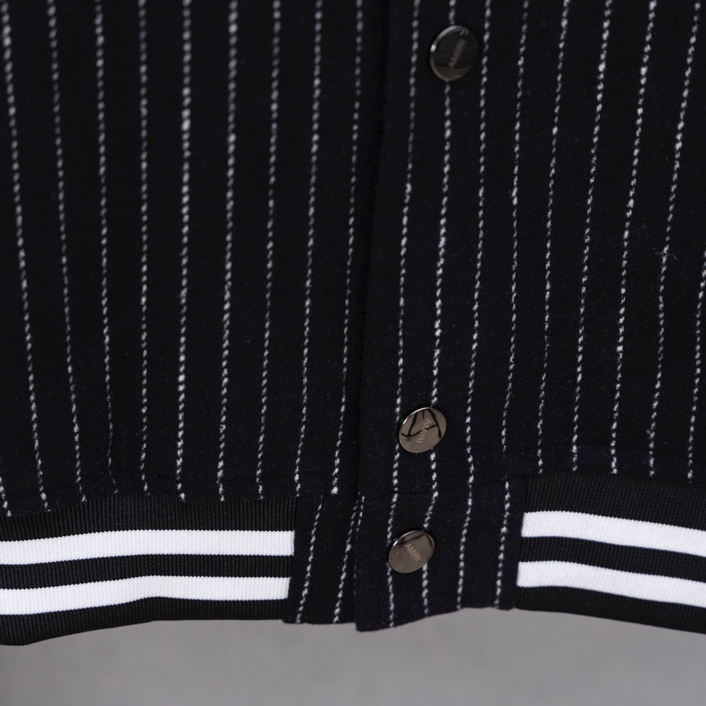 Pinstripe varsity jacket front with button placket and striped hem band