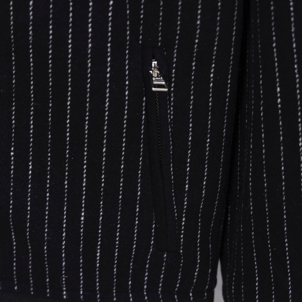 Back view of dark pinstripe varsity jacket with small logo tag