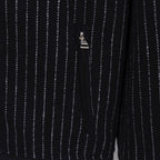 Back view of dark pinstripe varsity jacket with small logo tag