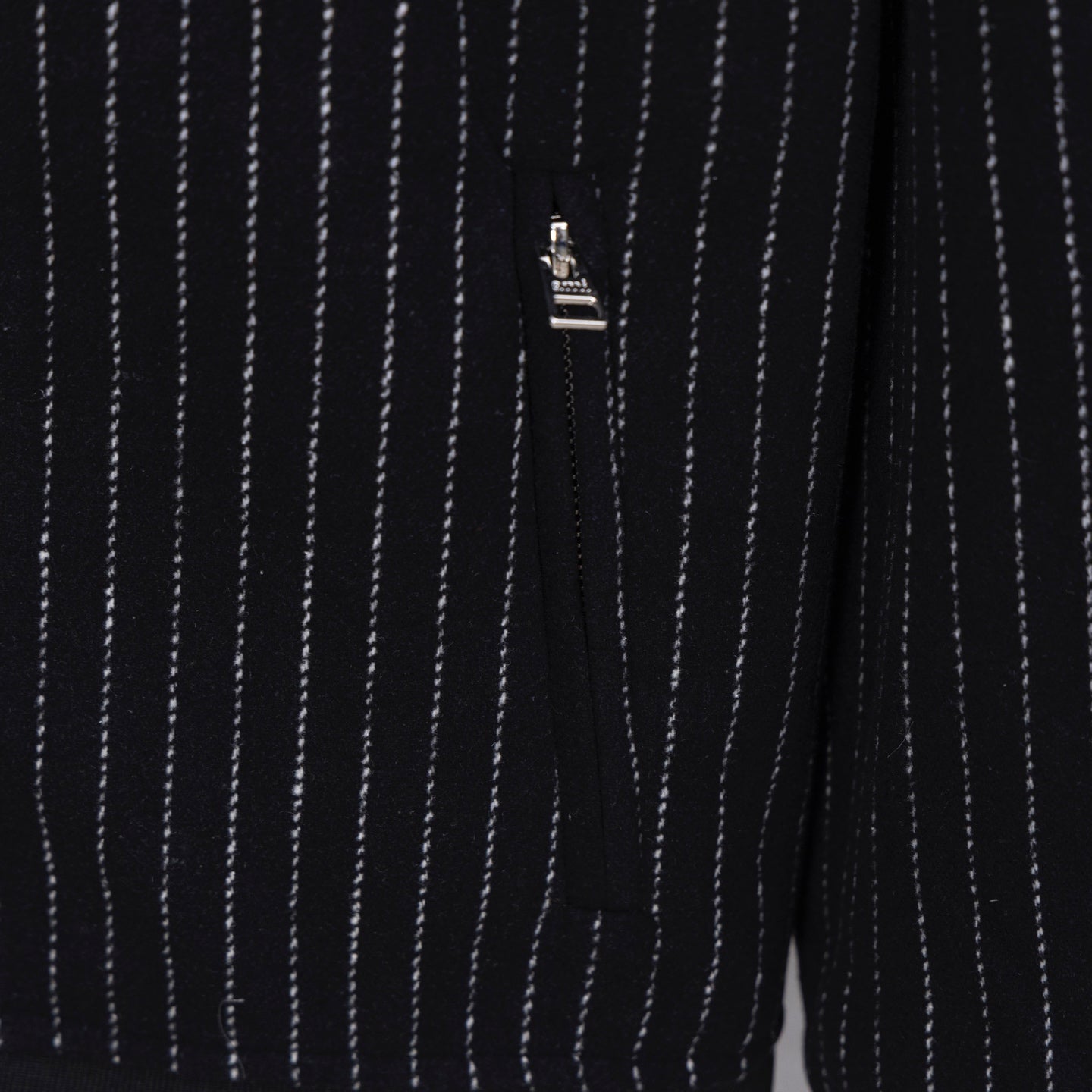 Back view of dark pinstripe varsity jacket with small logo tag