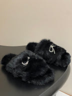 Black faux-fur slide sandals with rhinestone crescent straps