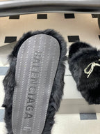 Black faux-fur slide sandal with textured tread sole and rhinestone strap