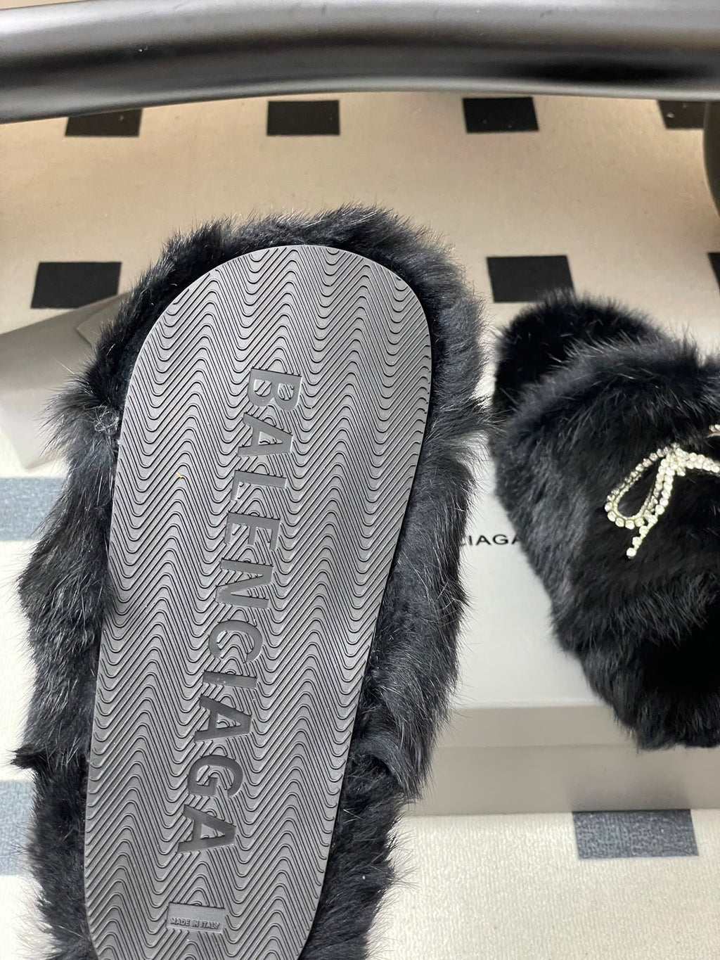 Black plush sandals with patterned rubber sole and crystal strap detail
