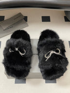 Black plush sandals with crystal bow strap detail, two slides shown