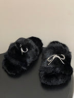 Black faux-fur slide sandals with rhinestone bow-strap detail