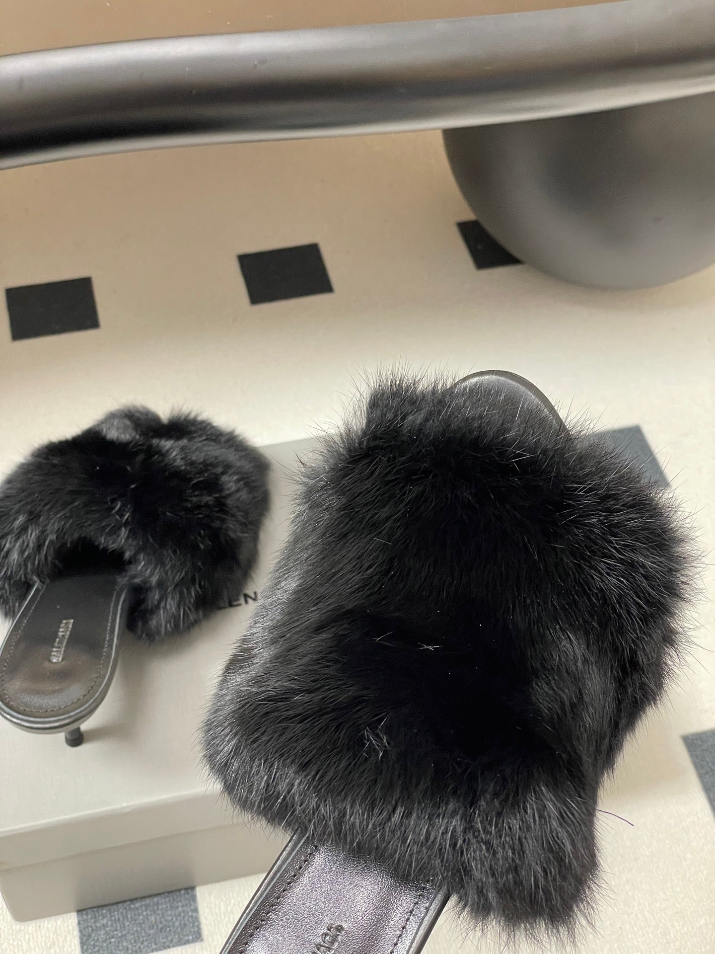 Black fur slide sandals with open back and thick fuzzy straps