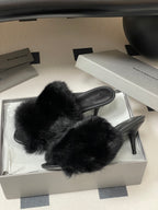 Black fur mules in box, open back and slim stiletto-style heel