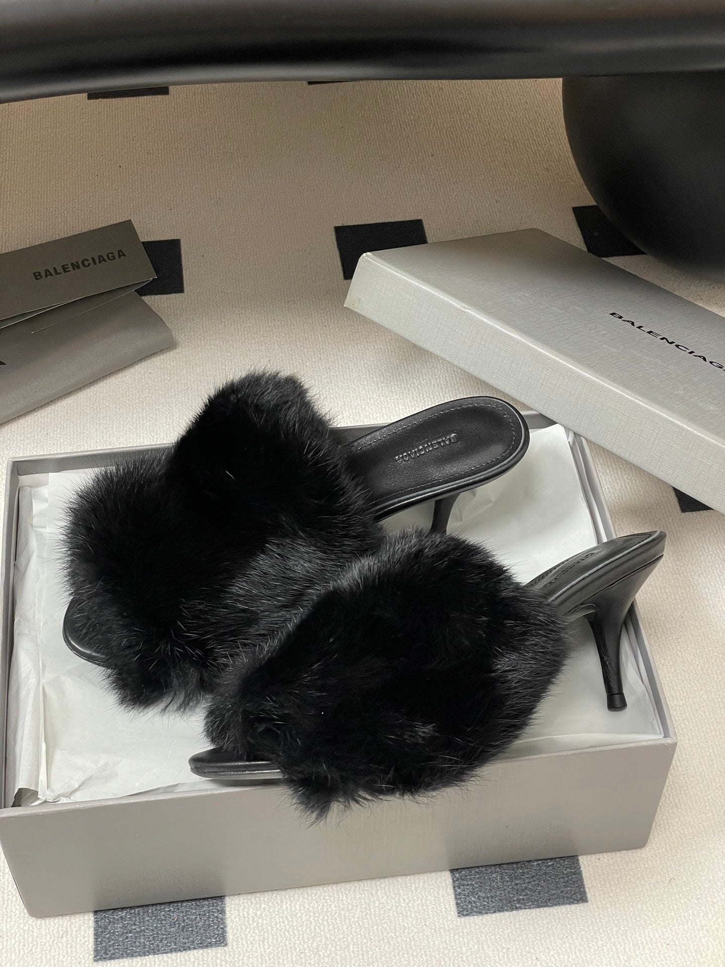 Black fur mules in box, open back and slim stiletto-style heel