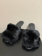 Black faux-fur slide sandals with wide crossover strap and low black heel