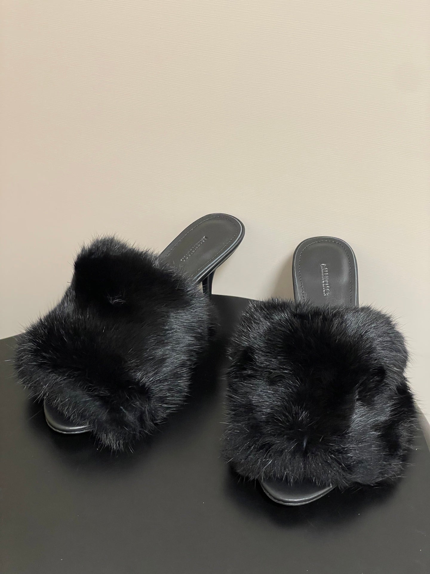 Black faux-fur slide sandals with wide crossover strap and low black heel