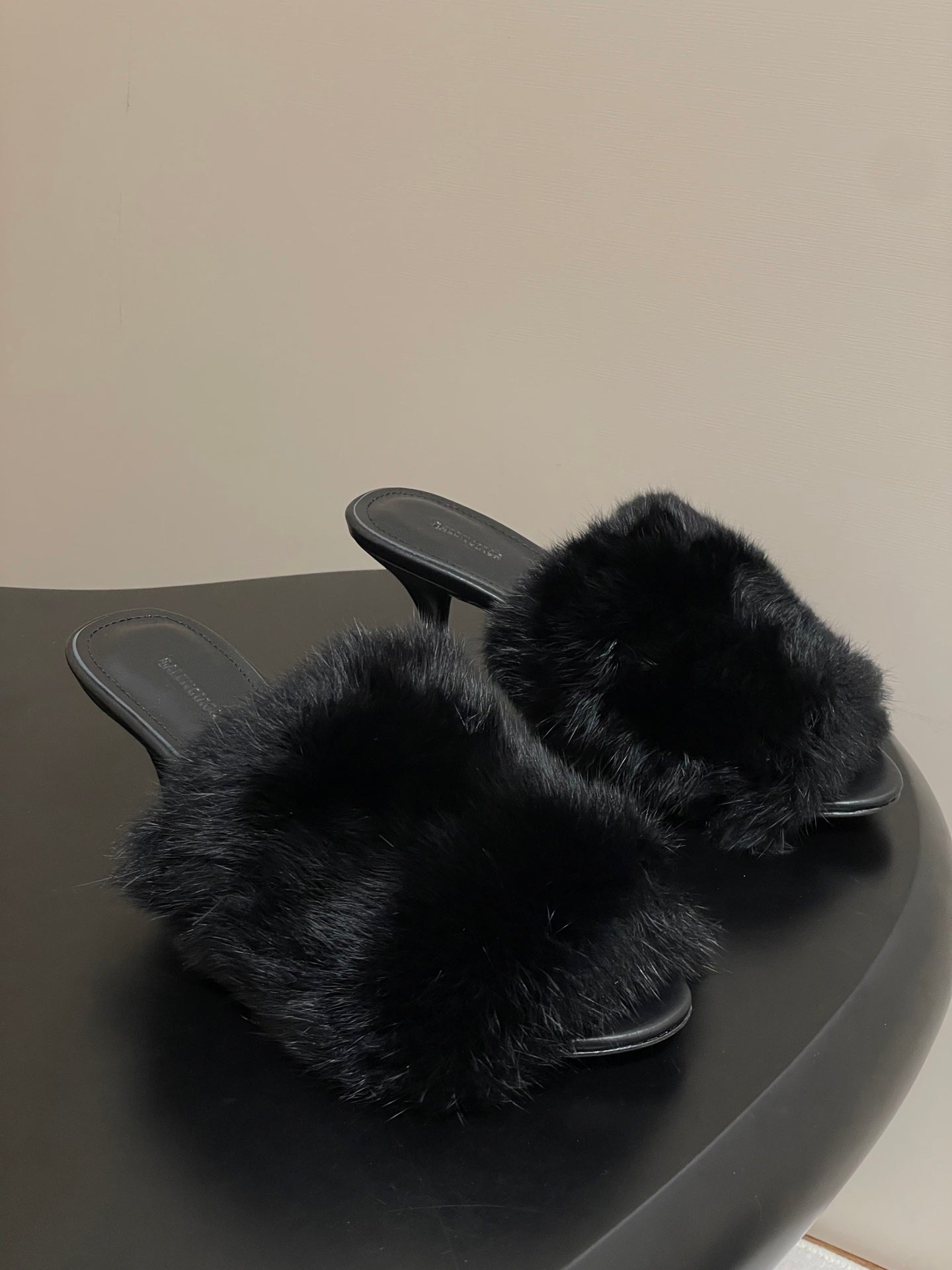 Black fur slide sandals with open back and slim black heel