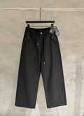 Black wide-leg pants with elastic waistband, front button, and side pockets.