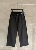 Black wide-leg pants with elastic waistband, front button, and side pockets.