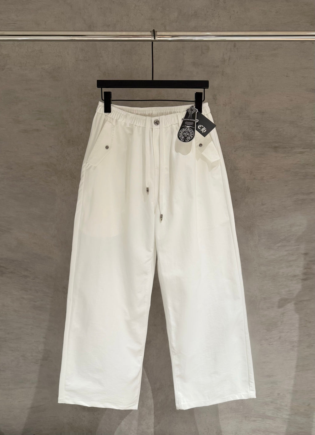 White wide-leg pants with drawstring waist and front button placket