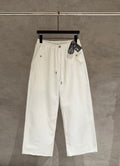 White wide-leg pants with drawstring waist and front button placket