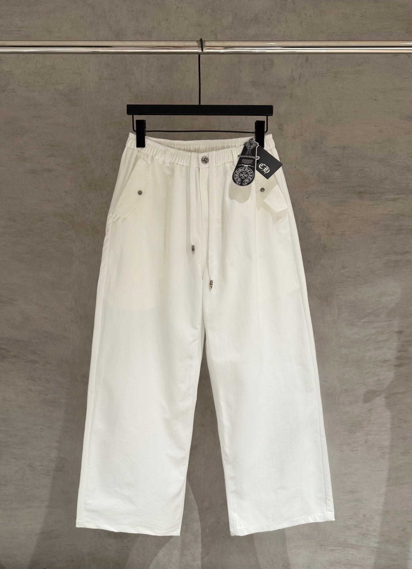 White wide-leg pants with drawstring waist and front button placket