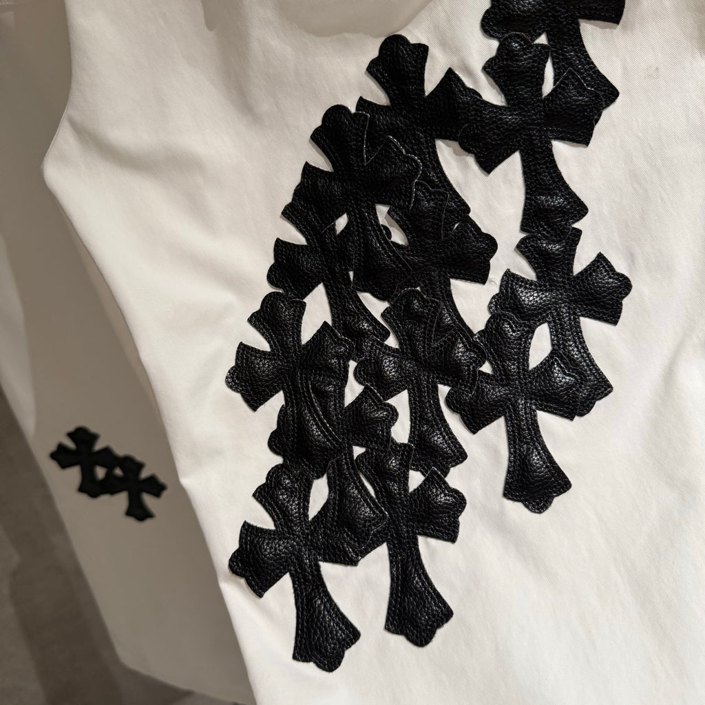 White pants with large black cross appliques on the leg