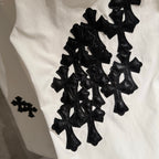 White pants with large black cross appliques on the leg