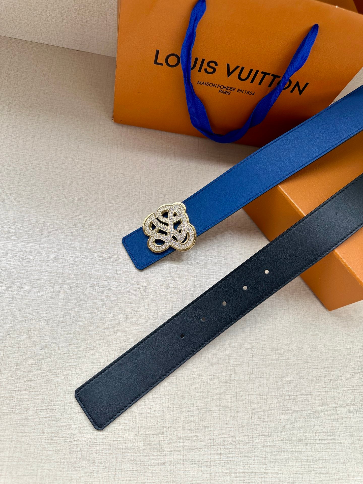 Louis Vuitton blue leather belt with gold-tone logo buckle and punched holes