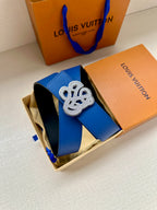 Louis Vuitton blue leather belt with gold-tone logo buckle, shown in box
