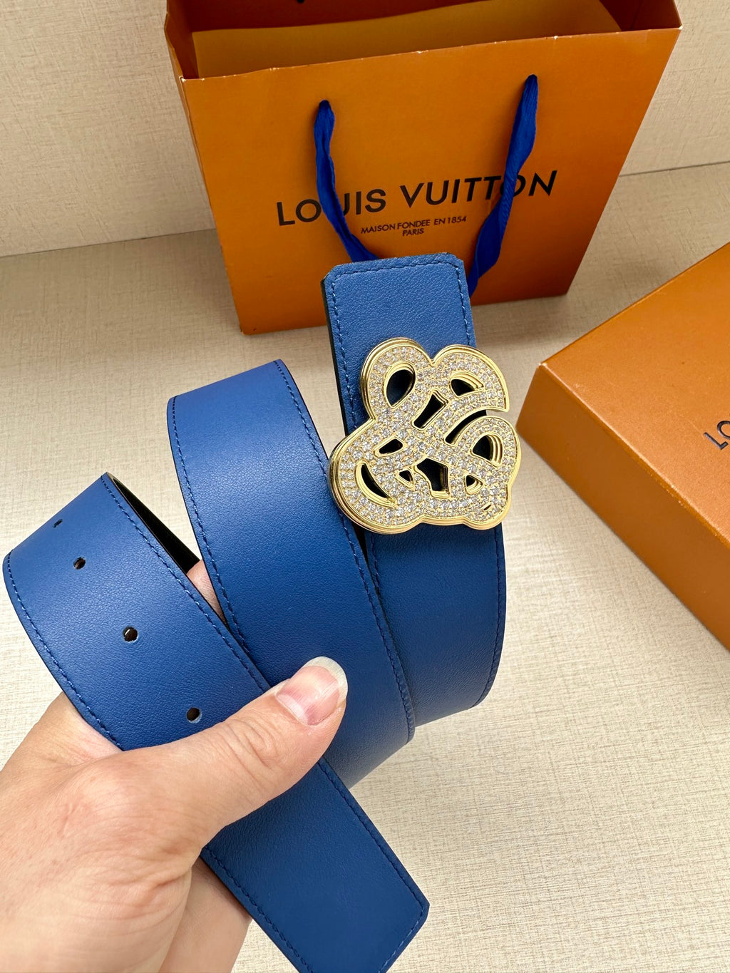 Louis Vuitton blue leather belt with gold-tone logo buckle and strap holes
