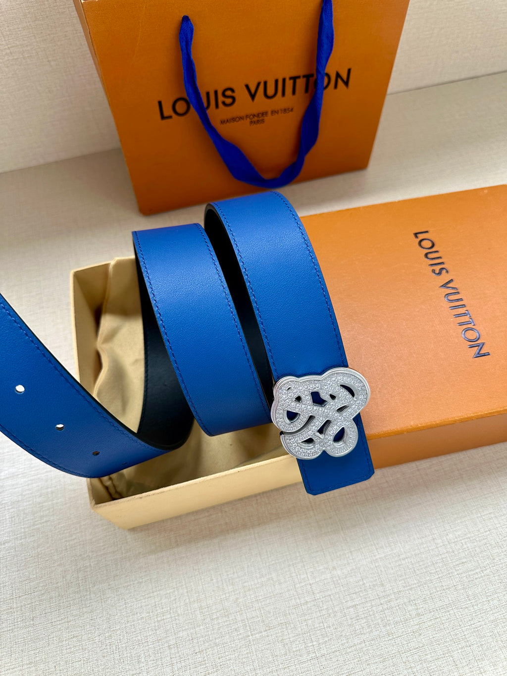 Louis Vuitton blue leather belt with gold-tone logo buckle on wide strap