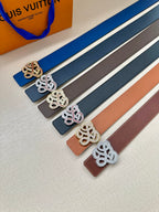 Assorted leather belts with logo buckles in gold, silver, and dark colors