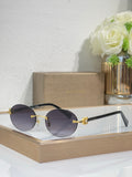 Gold-tone sunglasses with dark gray lenses and black temples, round lenses, jewel detail.