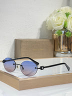 Blue-tone sunglasses with blue lenses and black temples, round lenses, small gold emblem.