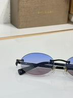 Bvlgari oval glasses with dark frames and blue-tinted lenses, gold bridge