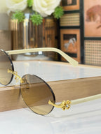 Bvlgari oval glasses with cream frames, gold details, brown-tinted lenses