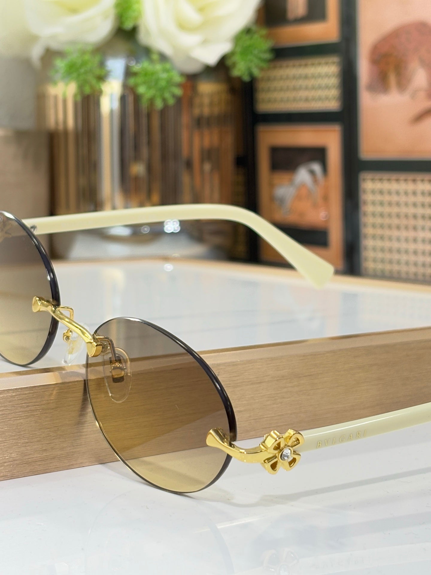 Bvlgari oval glasses with cream frames, gold details, brown-tinted lenses