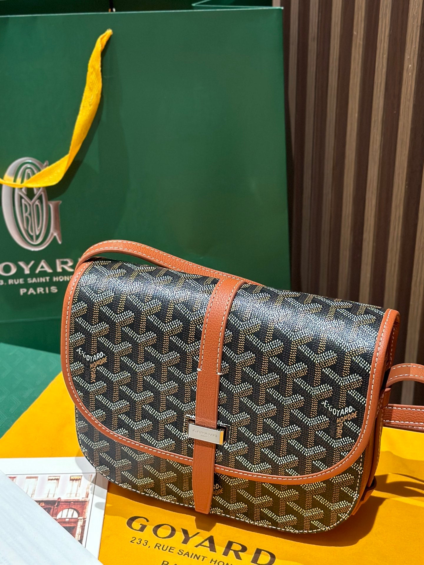 Goyard shoulder bag with gray patterned canvas, tan leather trim and long strap.