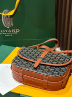 Goyard small shoulder bag with gray patterned body and tan handle, crossbody strap.