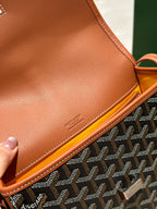 Goyard tan leather flap edge with embossed text and orange piping.