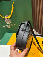 Goyard crossbody bag side view with structured black leather panel and shoulder strap