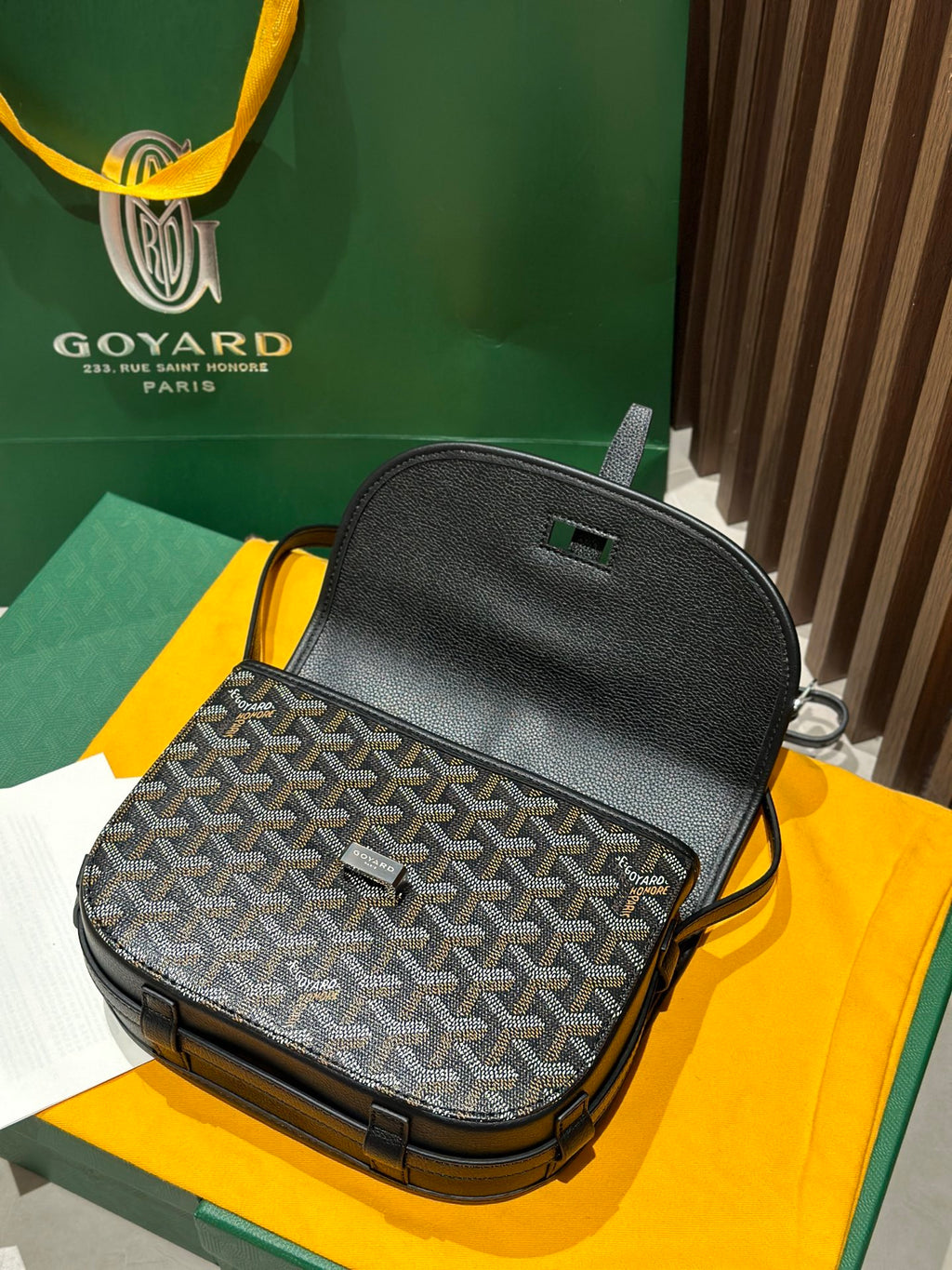 Goyard crossbody bag back view with textured black top and patterned front panel
