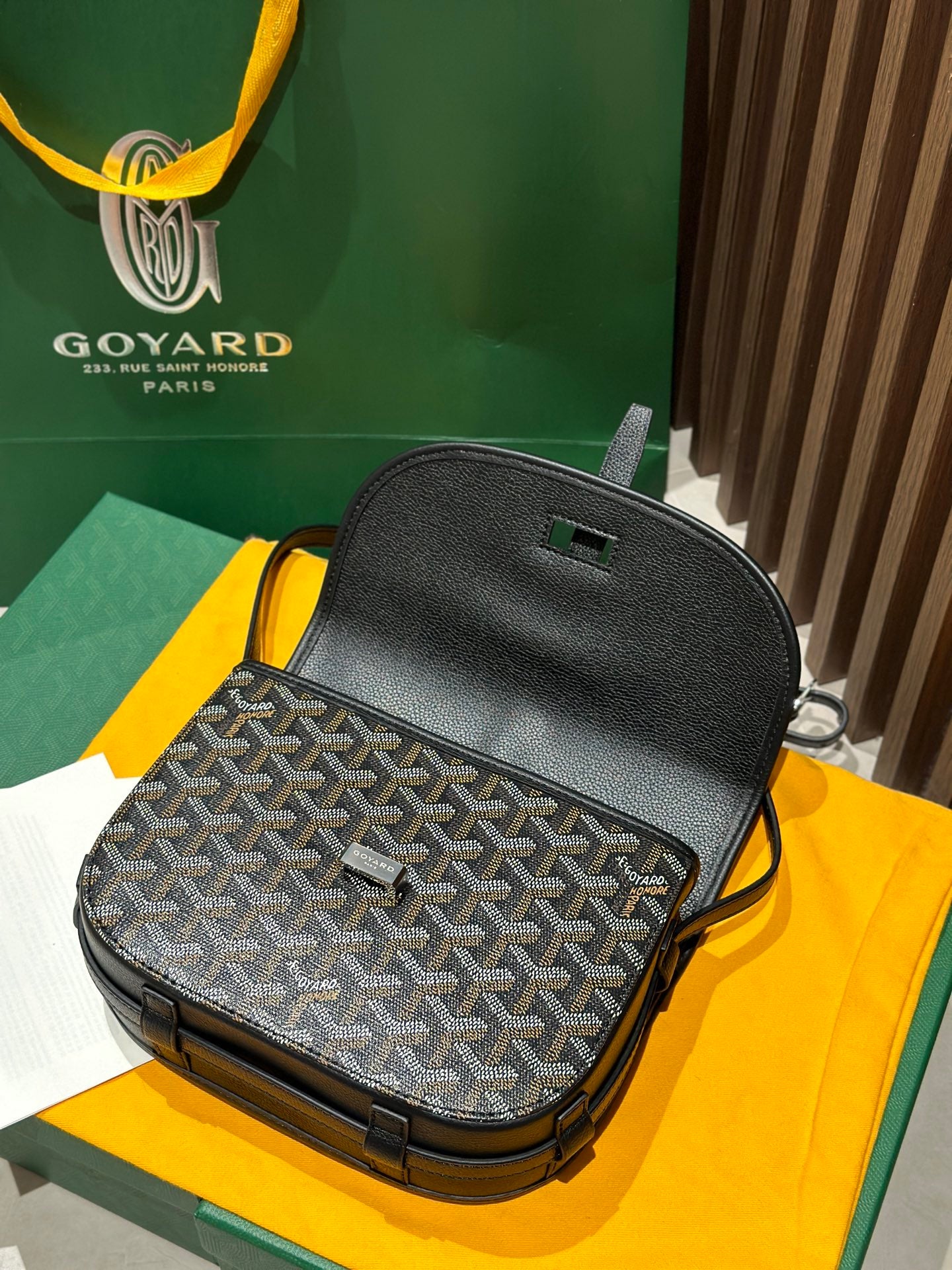 Goyard crossbody bag back view with textured black top and patterned front panel