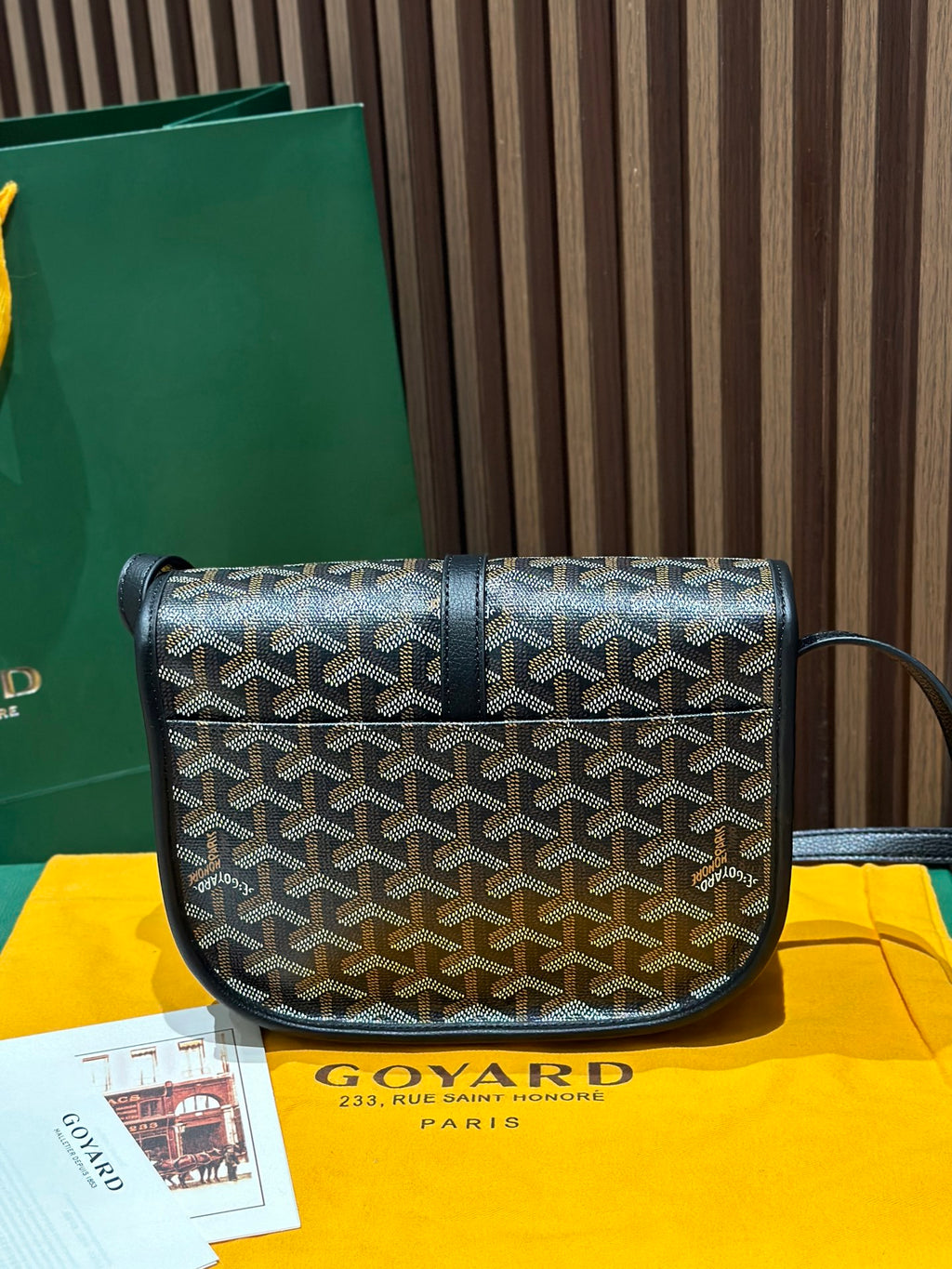 Goyard crossbody bag front view with patterned canvas, black flap, and crossbody strap