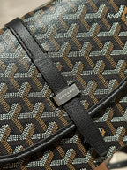 Goyard crossbody bag close-up of patterned canvas with black leather trim and logo patch