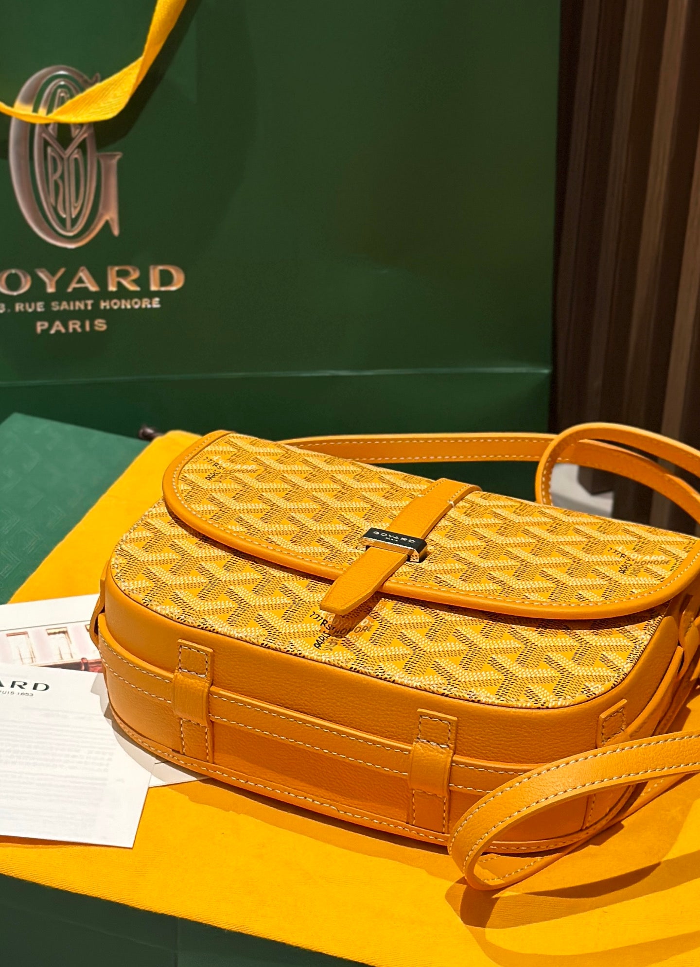 Goyard yellow patterned flap bag with adjustable strap and front buckle clasp