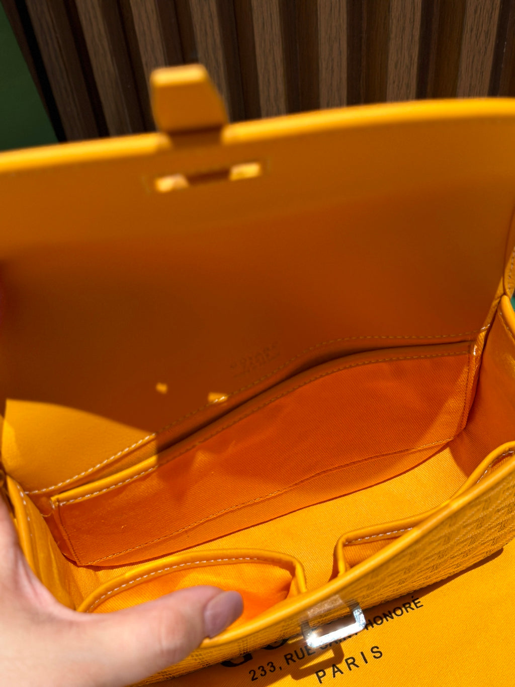 Goyard yellow crossbody bag interior shown open with strap and lining
