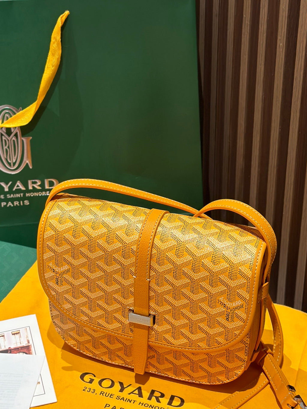 Goyard yellow patterned crossbody bag with adjustable shoulder strap and clasp
